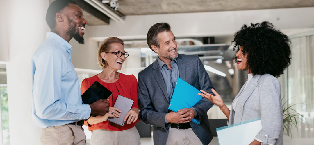 Group of happy co-workers discussing new project